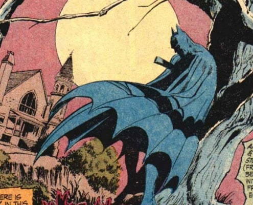 Batman standing under a dead tree in DC Comics
