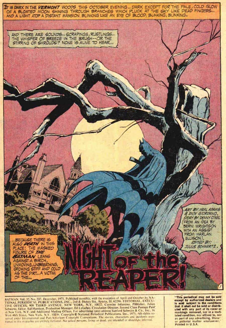 Batman standing under a dead tree in DC Comics