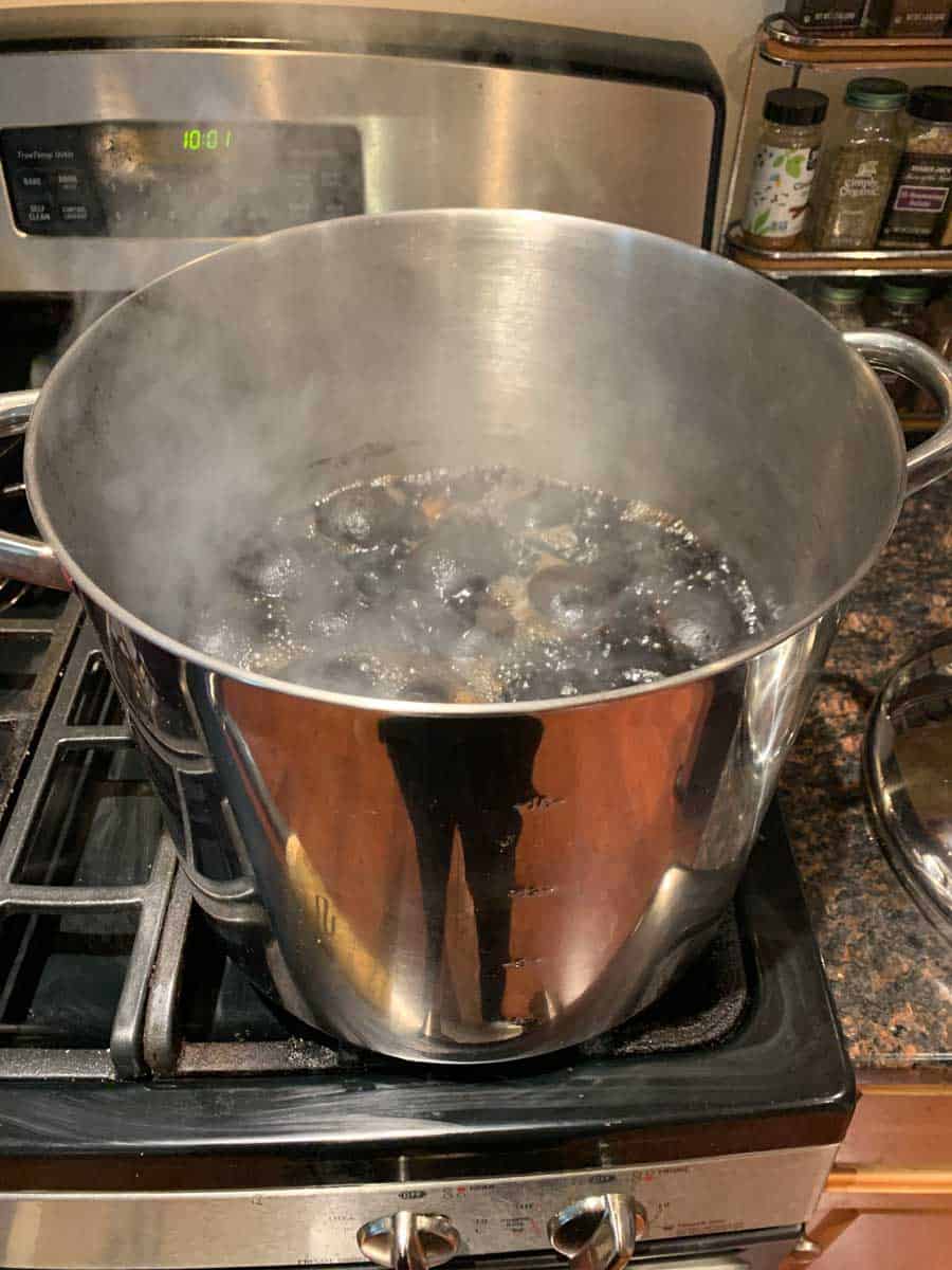 Pot of boiling walnuts being prepared for walnut ink.